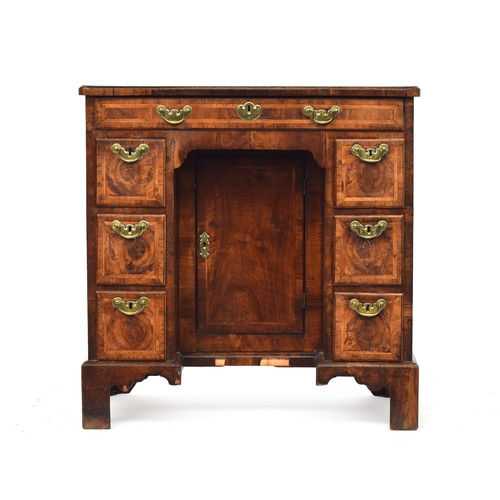 461 - A George II walnut lady's kneehole dressing table, c.1740, quarter veneered and cross banded top ove... 