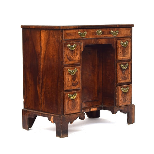 461 - A George II walnut lady's kneehole dressing table, c.1740, quarter veneered and cross banded top ove... 