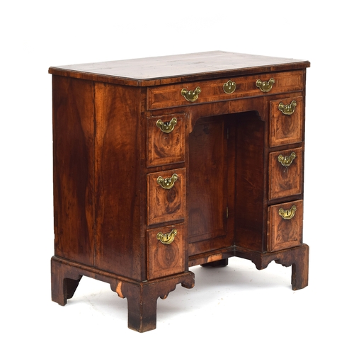 461 - A George II walnut lady's kneehole dressing table, c.1740, quarter veneered and cross banded top ove... 