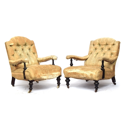 512 - A matched pair of 19th century armchairs in the manner of Howard & Sons, each with loose cover, butt... 