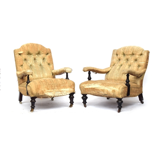 512 - A matched pair of 19th century armchairs in the manner of Howard & Sons, each with loose cover, butt... 