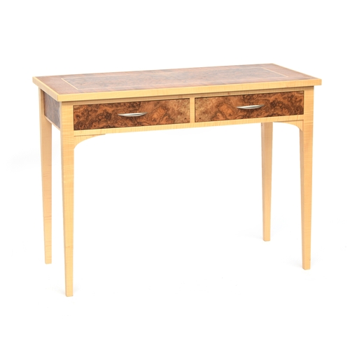 551 - A contemporary maple and burr walnut console table, with two frieze drawers, on plain square tapered... 