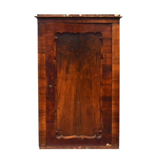 459 - A Biedermeier walnut cabinet, c.1820, the cupboard door with wavy edge, 102cm wide, 49cm deep, 159cm... 