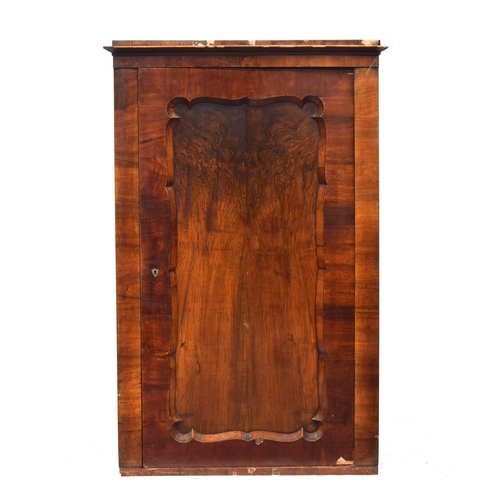 459 - A Biedermeier walnut cabinet, c.1820, the cupboard door with wavy edge, 102cm wide, 49cm deep, 159cm... 