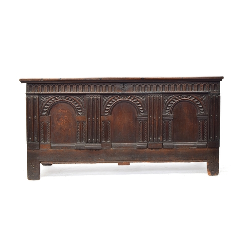 445 - A very large 18th century oak coffer, the front of three domed panels, with panelled back and sides,... 