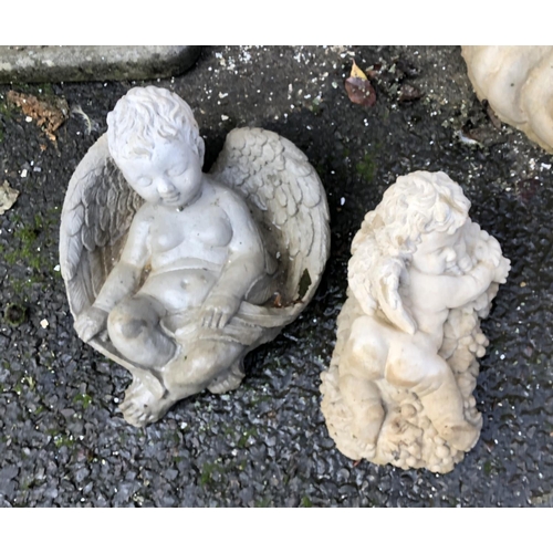 806 - Two composite stone cherubs, the larger 34cmH