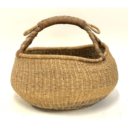 1209 - A rush basket with leather bound handle