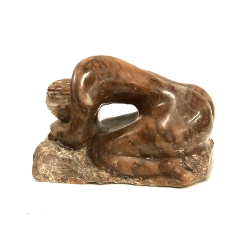 617 - A large carved hardstone figure of a kneeling nude, 37cmL