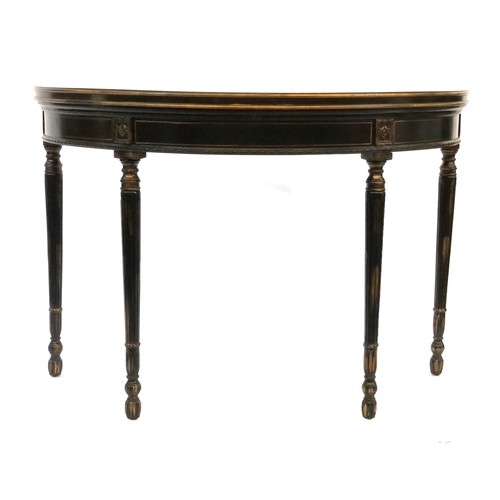 1114 - A pair of ebonised, polychrome and parcel gilt demilune console tables, of recent manufacture, paint... 