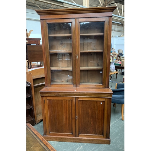 955 - A mahogany glazed library bookcase, the glazed top with three adjustable shelves, on a base with two... 