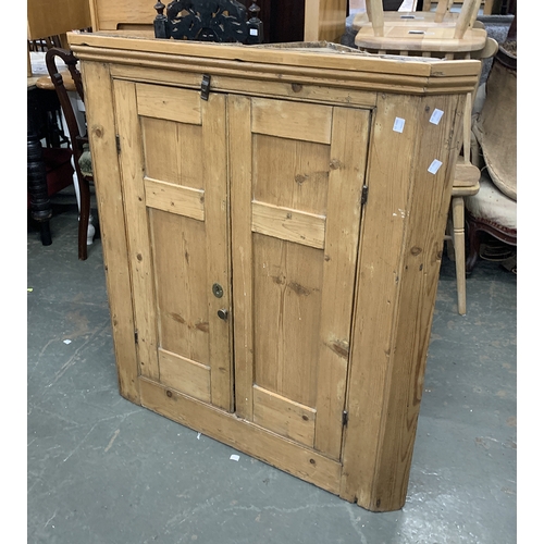 1102 - A 19th century stripped pine corner cupboard, 94cmW