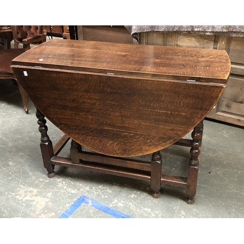 1111 - An oak gateleg table with single end drawer, 109cmW