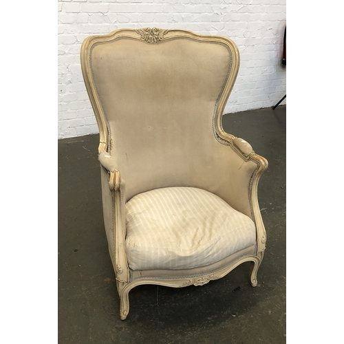 823 - A continental cream painted barrel back armchair with carved frame, feather filled squab cushion, 69... 