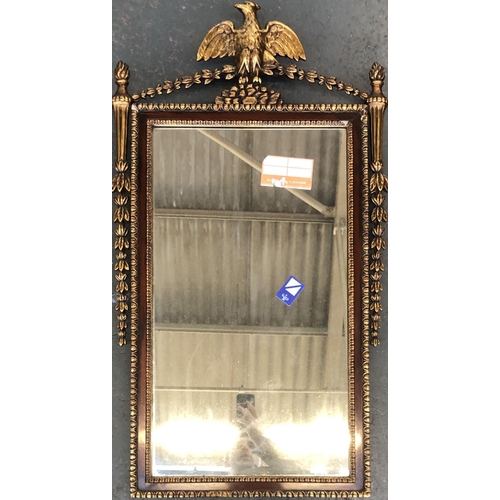 743 - A decorative giltwood wall mirror with eagle cresting, of recent manufacture, 98x55cm