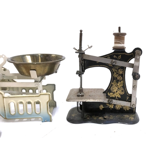 393 - A miniature toy sewing machine; toy kitchen scales; shop till; tessellating dolls house chairs and c... 