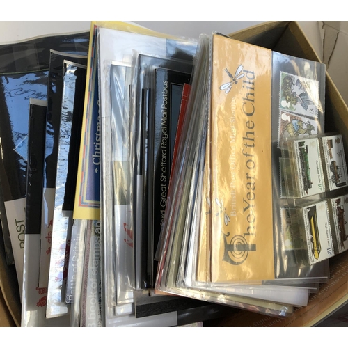 628 - A mixed lot in 4 boxes to include definitive and commemorative stamps, presentation packs, first day... 