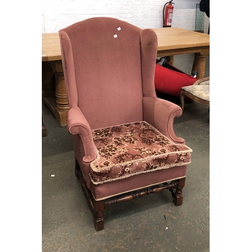 837 - A 20th century wingback armchair; together with a continental style bedroom chair upholstered in a f... 