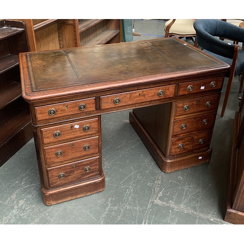 958 - A Victorian mahogany pedestal desk, tooled green leather skiver, over the traditional arrangement of... 