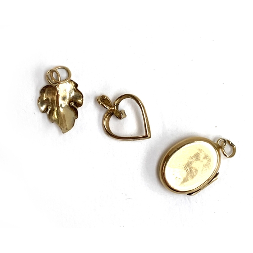 64 - Three pendants: a 9ct leaf, 1.7cmL, 0.4g; a 9ct heart, 0.5g; and a 9ct back and front locket, 2g (3)