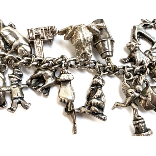 79 - A heavy silver charm bracelet, 112g