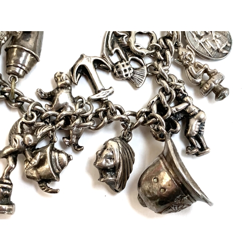 79 - A heavy silver charm bracelet, 112g