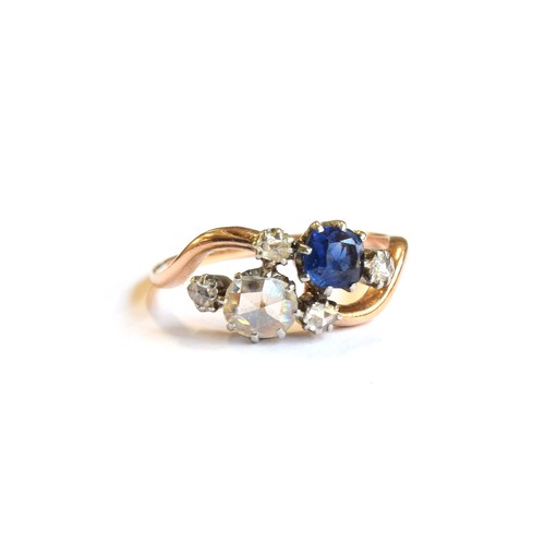 54A - An early 20th century 18ct gold 'Toi et Moi' diamond and sapphire crossover ring, the large rose cut... 