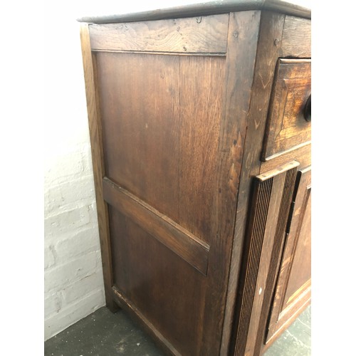 448 - A George III oak dresser base, comprising three drawers, two central drawers flanked by cupboard doo... 