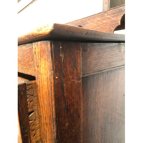 448 - A George III oak dresser base, comprising three drawers, two central drawers flanked by cupboard doo... 