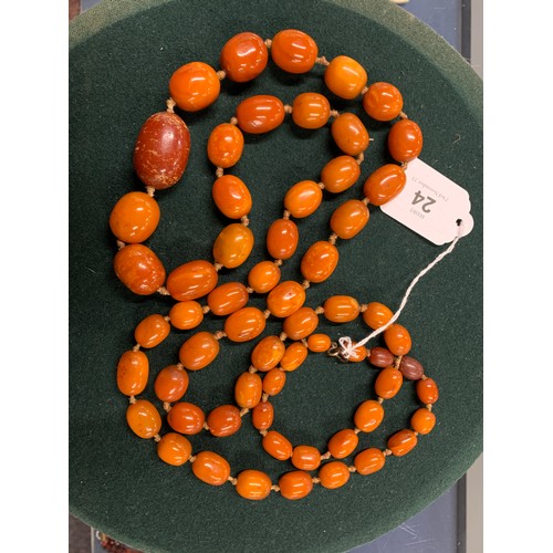 24 - An early 20th century amber bead necklace, knotted, the beads graduating from 1.1cm to 3.3cm, unclas... 