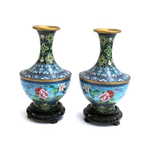 370 - A pair of Chinese cloisonne enamel vases, depicting cranes and flowers, 25cm high, each on a carved ... 