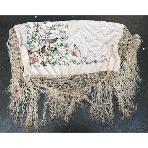 380 - A 1920s cream silk piano shawl with fringe, embroidered with songbirds amongst flowers, the central ... 