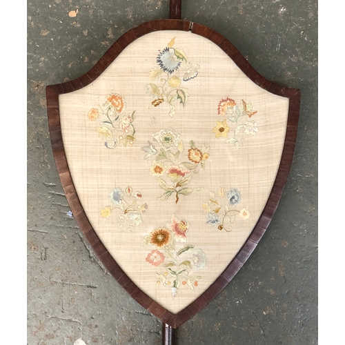 826 - A 19th century floral needlework framed as a shield shaped fire screen, 37x45cm