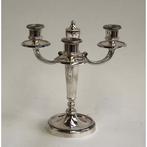 71 - A Christofle France 'Collection Gallia' silver plated three arm candlestick, 22cmH