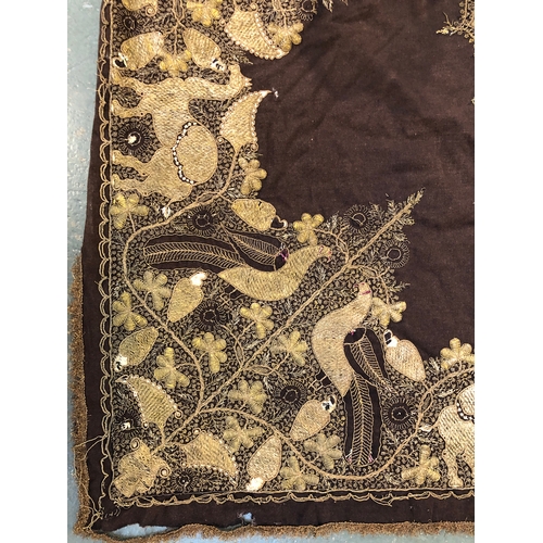 412 - A Indian wool throw with metal thread embroidery depicting camels and peacocks surrounding a central... 