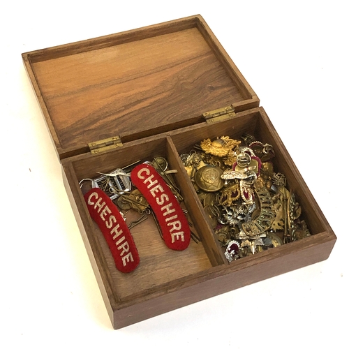 441 - A collection of Cheshire regiment cap badges, buttons etc, in a wooden box etc