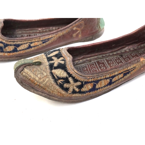 454 - A pair of Indian Mughal leather children's shoes embroidered with metal thread