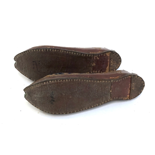 454 - A pair of Indian Mughal leather children's shoes embroidered with metal thread