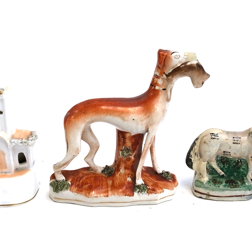 293 - Four Staffordshire figures (af): Staffordshire greyhound with quarry; together with a Staffordshire ... 