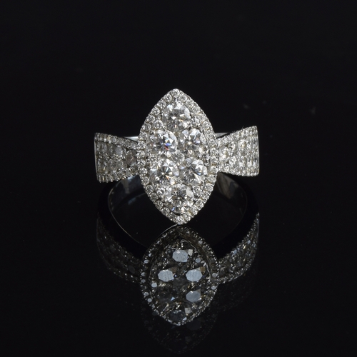A substantial 18ct white gold diamond ring of navette form, the six central large diamonds set overlapping smaller diamonds in-between for full coverage, with diamond set shoulders, set with a total of approx. 2.6cts of brilliant cut diamonds of varying sizes, size R, 7.6g
