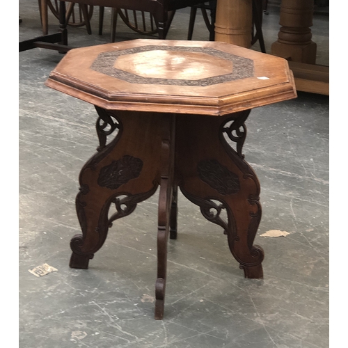 1127 - An octagonal carved hardwood occasional table on folding base, 57x54cmH