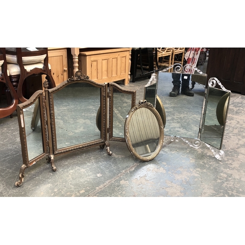 1140 - Two three part dressing table mirrors; together with a further oval mirror in gilt gesso frame