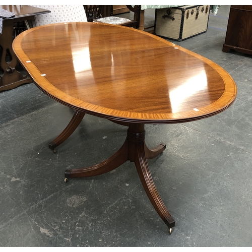 1141 - An extending mahogany D end dining table in Regency style, on two triform bases with swept legs and ... 