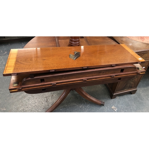 1141 - An extending mahogany D end dining table in Regency style, on two triform bases with swept legs and ... 