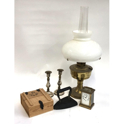 616 - METAL WARES: an oil lamp with chimney and shade together with a French carriage clock (a/f) and a he... 