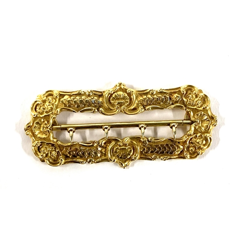 9 - A heavy 19th century gold buckle, unmarked but tests as 18ct, with shell and floral motifs, 8cm long... 