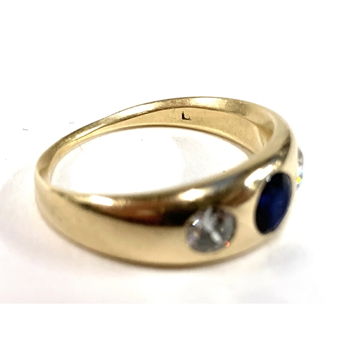 13 - A gold gypsy ring set with diamonds and a central sapphire, marks rubbed but tests as 14ct or higher... 