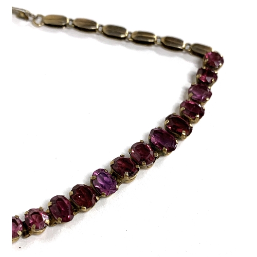 21 - A gilt metal mounted garnet bracelet, 18cmL