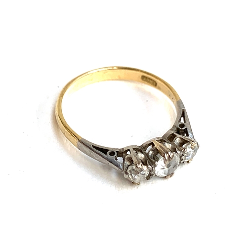 6 - An 18ct gold trilogy ring, set with two diamonds and a central paste replacement stone, size L, 2g