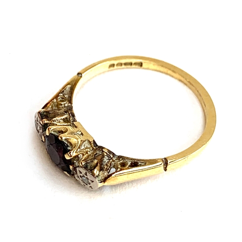 7 - An 18ct gold, diamond and garnet trilogy ring, size M, 2.4g