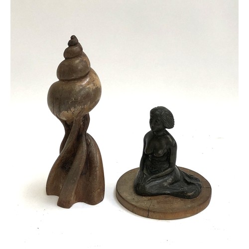 483 - Two sculptures by the same artist, a carved wooden sculpture of a shell, 29cmH, and a figure of a la... 